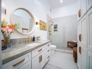 a bathroom with a sink and a mirror at Exclusive Oceanfront Access at Alaeloa #3 in Kahana +49 photos