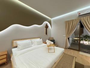 a bedroom with a large white bed and a window at Villa Paapa & Maama Luxurious Private Pool in Johor Bahru +30 photos