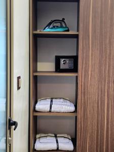 a book shelf with a radio and two pillows at Scenic Tamraght Cozy Studio in Agadir +52 photos