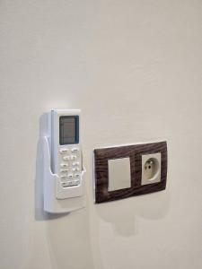 a cell phone hooked up to a light switch at Scenic Tamraght Cozy Studio in Agadir