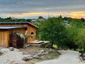 a wooden cabin with a porch and a deck at Cabañas colibrí in Villa Carlos Paz