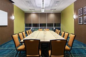 a conference room with a long table and chairs at SpringHill Suites by Marriott Pensacola in Pensacola +8 photos