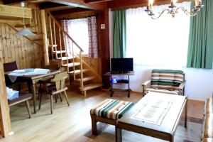 a living room with a table and a dining room at Lissis Alpennest in Gosau