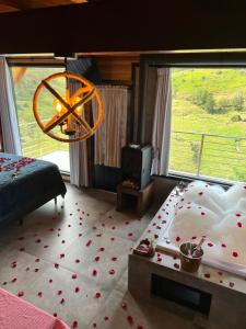 a bedroom with a large window with a bed and a chandelier at Sitio do Galdino in Armazém +30 photos