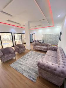 a living room with couches and a rug at Camara's Home in Sali Nianiaral