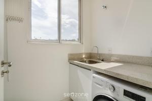 a kitchen with a sink and a washing machine at Apartamento c/ Churrasqueira 240m da Praia EHI0401 in Praia Brava +17 photos