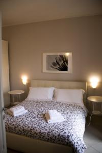 a bedroom with a bed with two towels on it at "le Volte" Appartamento nel cuore di Foligno in Foligno
