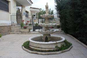 a fountain in a courtyard in front of a house at Hotel Las Nieves in Las Nieves