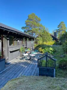 a wooden deck with a table and chairs on it at 1960's Architect Villa with Stunning Views in Trondheim