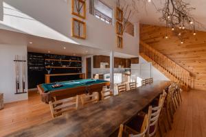 a large dining room with a pool table at Les 3 Vallées - 1911 in Saint-Férréol-les-Neiges