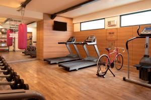 a gym with a treadmill and a bike in a room at MOXY Bandung in Bandung