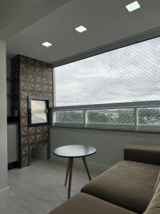 Μια τηλεόραση ή/και κέντρο ψυχαγωγίας στο Apartamento Bairro Floresta