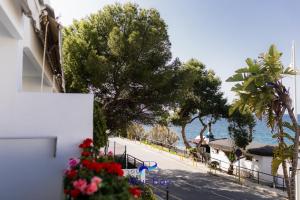 a building with flowers on the side of a street at Bliss On The Bay Apartment in La Herradura