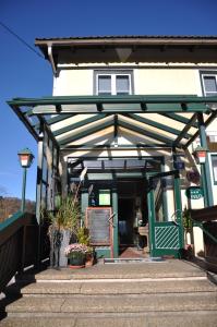 a building with awning and stairs in front of it at Gasthof Linko in Traisen