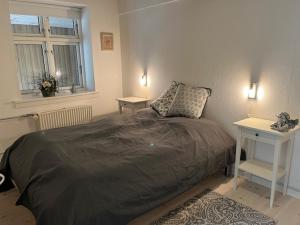 a bedroom with a bed and a table and a window at Ved Holckenhavn Fjord in Nyborg +13 photos