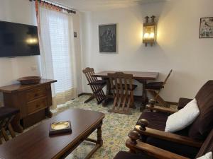 a living room with a table and a dining room at CERVINIA CITY CENTER in Breuil-Cervinia