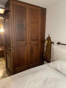 a bedroom with a wooden cabinet and a bed at CERVINIA CITY CENTER in Breuil-Cervinia