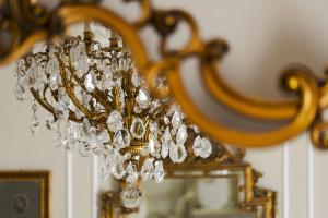 a chandelier hanging in front of a mirror at B&B Palazzo Cerami in Catania