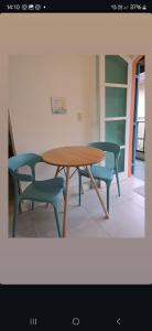 a table and two chairs and a table and chairs at Suites Nativa in Ubatuba +14 photos