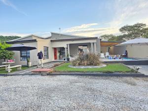a man standing in front of a house at Morokolotsi Guest House in Tzaneen