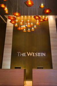 a sign for the westin with lights hanging from it at The Westin Panama in Panama City