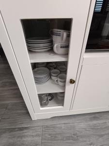 a cupboard with plates and dishes in it at Cuore di toscana in Colle Val D'Elsa