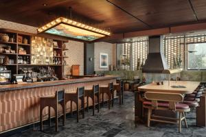 un restaurante con un bar con sillas alrededor en Blueground Downtown pool AC nr Capitol ATX-292, en Austin