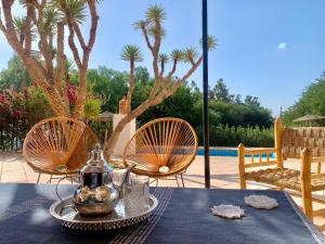 a table with a tea kettle on top of it at Le Domaine d'Eden - Villa luxueuse, piscine, spa et personnel in Essaouira
