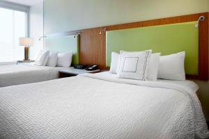 a hotel room with two beds with white pillows at SpringHill Suites by Marriott Columbus OSU in Columbus +17 photos