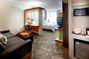 a hotel room with a couch and a bed at SpringHill Suites by Marriott Columbus OSU in Columbus