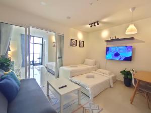 a living room with a couch and a table at The ocean city view in Kota Kinabalu