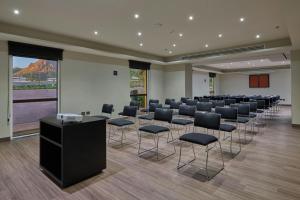 a conference room with a row of chairs and a podium at City Express by Marriott Guaymas in Guaymas