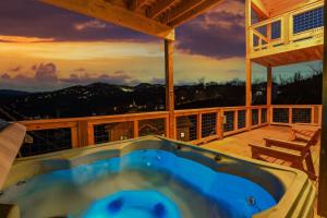 a hot tub on the deck of a house at Big Bear Shack - Handicap Accessible & Dog Friendly in Gatlinburg
