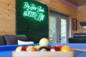 a ping pong table with a sign that says big ball starts at home inn at Big Bear Shack - Handicap Accessible & Dog Friendly in Gatlinburg
