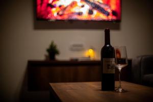 a bottle of wine and a glass on a table at Spiky hill resort in Kopaonik