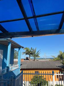 a view of the ocean from the balcony of a house at Pousada Cantinho Azul Qt 01 in Passo de Torres