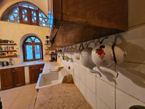 a large kitchen with a sink and a counter at Beit Ain al Haya in Fayoum +44 photos