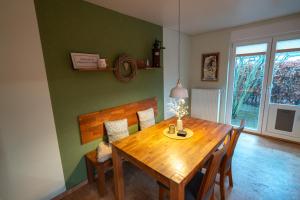 a dining room with a wooden table and chairs at Ferienhaus Glücklich am Harz in Goslar