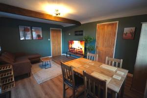 un soggiorno con un tavolo di legno e una televisione di Bridge Sawmill holiday cottage a Tetford