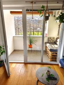 a living room with a sliding glass door at Family Nest near Ljubljana with free parking in Dobrova