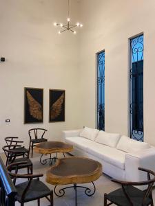 a living room with a white couch and chairs at Hacienda Mi Soledad in Balancán de Domínguez +24 photos