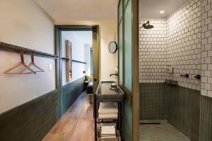 a bathroom with a sink and a shower at MOXY NYC Times Square in New York