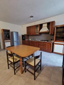 a kitchen with a wooden table and chairs at Meris affittacamere in Monsano +22 photos