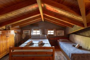 a bedroom with two beds in a attic at Beetle Villa retro country house in Kineta