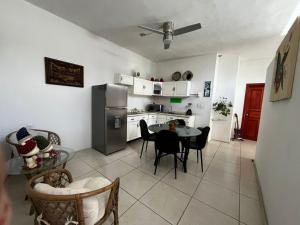 a kitchen with a table and a stainless steel refrigerator at Liah Amplio y Cómodo cuarto privado en Zapopan in Guadalajara