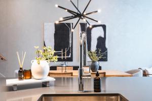 a kitchen with a sink with a faucet and vases at Tremblant Prestige - Verbier 4-202 in Mont-Tremblant +26 photos