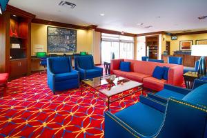a lobby with red and blue couches and blue chairs at TownePlace Suites by Marriott El Paso Airport in El Paso