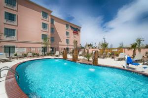 a large swimming pool in front of a hotel at TownePlace Suites by Marriott El Paso Airport in El Paso