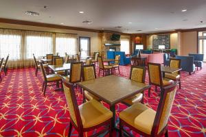a restaurant with tables and chairs on a red carpet at TownePlace Suites by Marriott El Paso Airport in El Paso