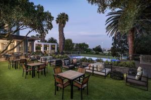 a restaurant with tables and chairs on the grass at Protea Hotel by Marriott Johannesburg Wanderers in Johannesburg